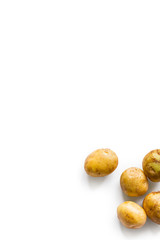 beautiful small rounded whole organic potato with the peel isolated on a white background. Vertical composition. Top view