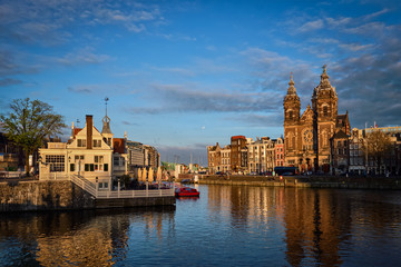 Obraz premium Amsterdam canal and Church of Saint Nicholas on sunset