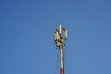 cell phone network antenna with blue sky background