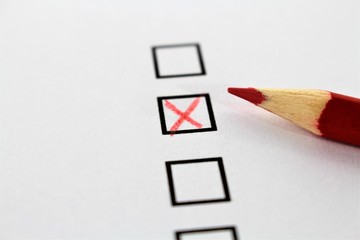 An concept Image of a red pencil and a questionnaire