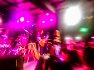 Fototapeta na wymiar The live music Room39 scene of the pop band is very popular with the audience. Concert pictures at night time. Abstract photo blur