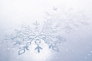 Background for christmas and new year. Light blue snowflake texture with sparkles close-up macro with soft focus. Template for the congratulate text.