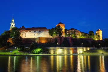 Fototapeta na wymiar Night view of the Vistula River and Wawel Castle in the Polish city of Krakow.