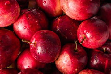 Red apples background, pile of fresh apple fruits, natural textu