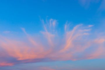 Red cirrus cloud with blue sky.