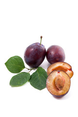 Fototapeta premium Group of whole and half of ripe plums with leaf isolated on a white background..