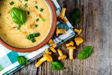 Creamy mushrooms soup, overhead on wooden table, seasonal mushroom dish