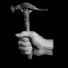 hammer- tools in a man's hand - black and white photo