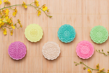 Colorful snow skin mooncake with tea pot on pink background