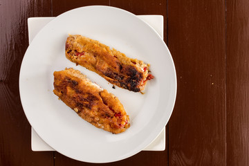 Flat lay fried grilled paprika in the eggs served on the white p