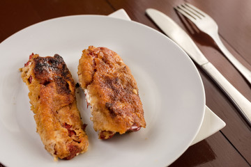Grilled and fried in eggs paprika with knife and fork on the pla