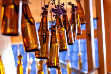 Brown glass bottles with flowers for background.