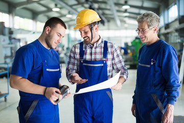 Engineer Teaching Apprentices To Use Computerized cnc metal processing machines