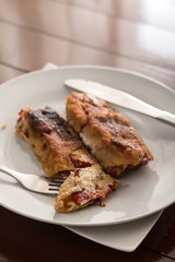 Grilled and fried in eggs paprika with knife and fork on the plate