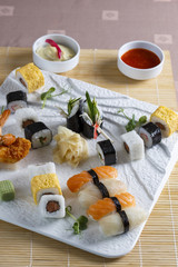Sushi served on plate with sauces