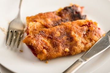 Grilled and fried in eggs paprika with knife and fork on the plate
