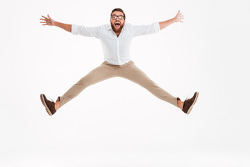 Cheerful young bearded man jumping.