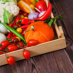 Fresh autumn vegetables in wooden box organic food concept. harvest raw eating healthy diet background copy space square