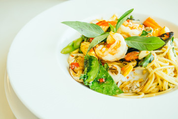 Spicy seafood spaghetti or pasta in white plate