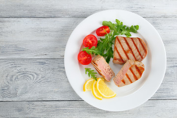 grilled tuna steak with salad and lemon