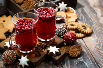 Christmas drink hot cranberry tea and cookies on dark background