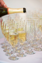 Waiter is pouring champagne outdoor
