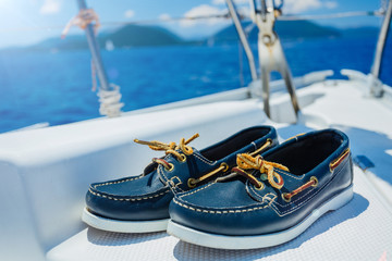 Navy top sider shoes on the wood background