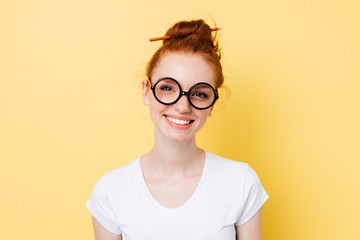 Image of smiling ginger woman in yeglasses looking at camera