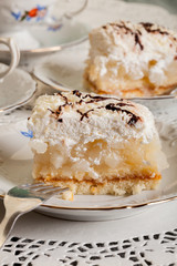 Fresh sweet apple cake with whipped cream served with cup of tea