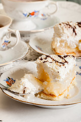 Fresh sweet apple cake with whipped cream served with cup of tea