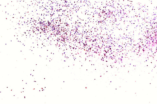 Purple glitter sparkles on white background.