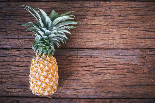 Ripe pineapple on a old wooden table