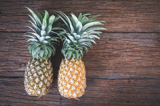 Ripe pineapples on a old wooden table