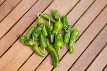 a pile of Pimientos de Padron on a wooden Table