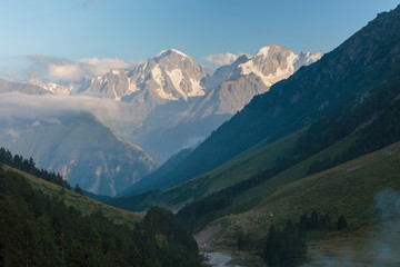 Obraz premium Russia, Republic of Kabardino-Balkaria, time lapse. Summer in the mountains of the Caucasus. Formation and movement of clouds over mountains peaks.