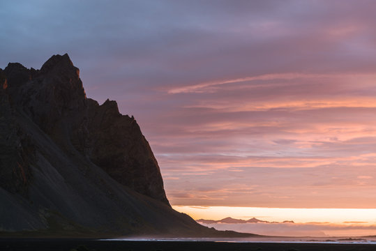 Sunrise at Stokksnes beach Iceland with mountain and orange and purple clouds