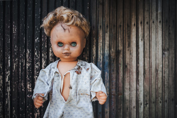 The old doll sitting in the doorway. Old wooden shed. Fear, hate, horror, loneliness.