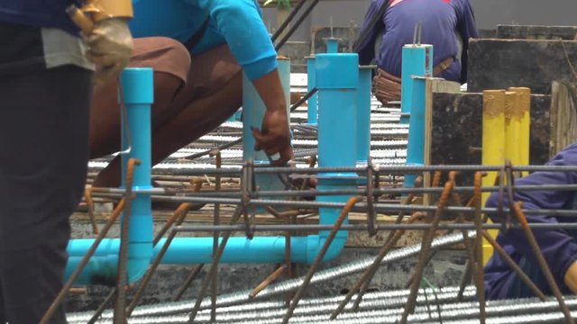 Construction workers pour concrete mix from cement mixer and trowel flat. Slow Motion. Slowmo