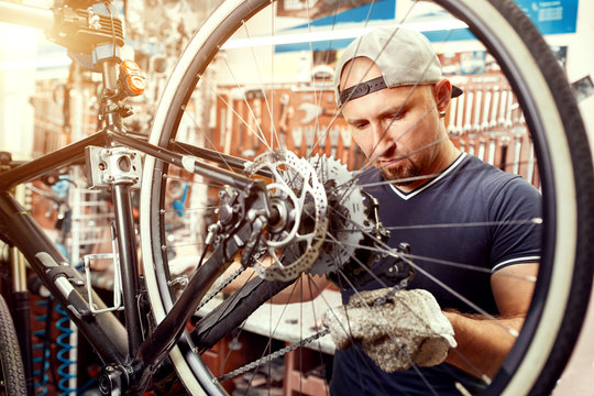 Bicycle mechanic in a workshop in the repair process
