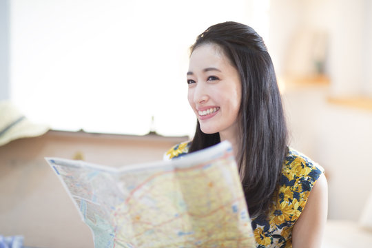 Smiling woman planning vacation