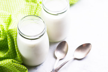 Fresh homemade greek yogurt in glass jars.