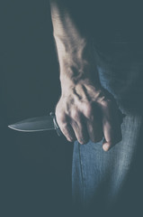 The man with a knife in a hand. Concept of crime, violence and terrorism.