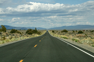 A very long long straight road throug american desert