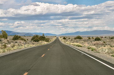 A very long long straight road throug american desert