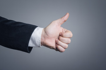 Businessman hand giving thumbs up