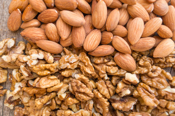 Walnuts and almonds are located horizontally, background, texture