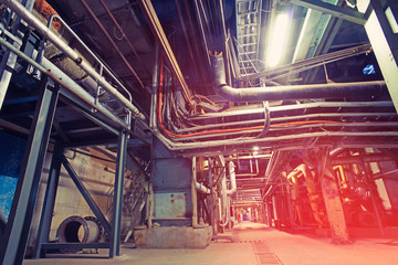 Equipment, cables and piping as found inside of a modern industrial power plant