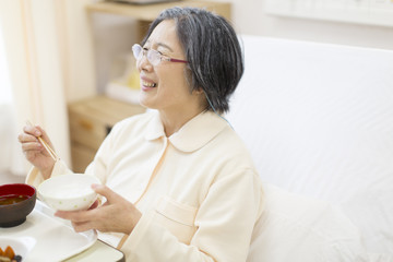 Patient eating meal in hospital bed