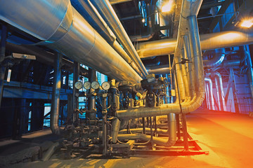 Equipment, cables and piping as found inside of a modern industrial power plant