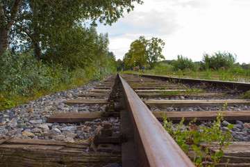 Fototapeta na wymiar Railway tracks lead by nature and cyclists